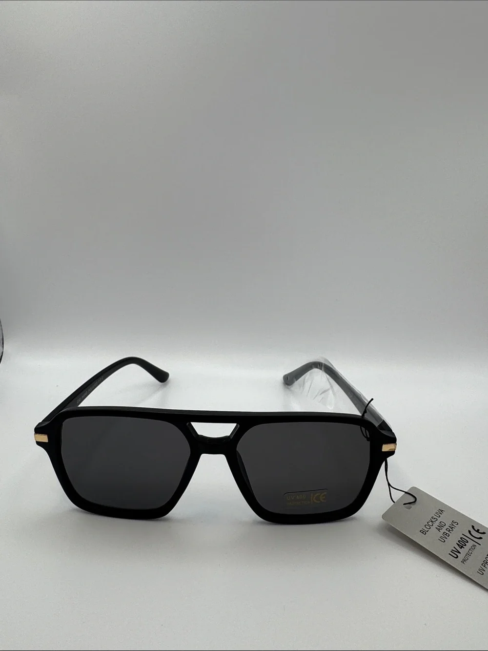 Black Sunglasses with Dark Lenses and Gold Accents